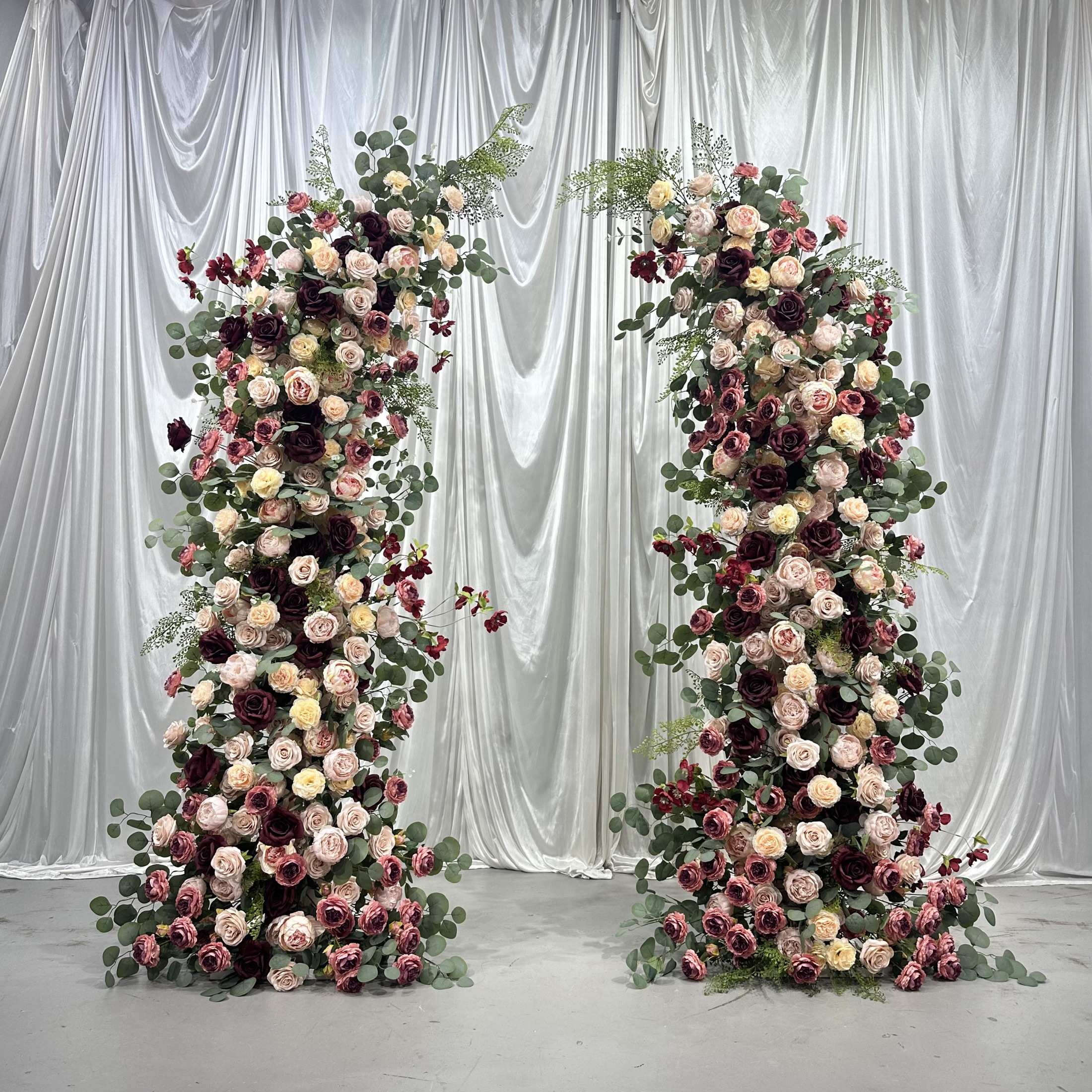 U-shaped faux-flower arch in wine, burgundy, blush and champagne tones