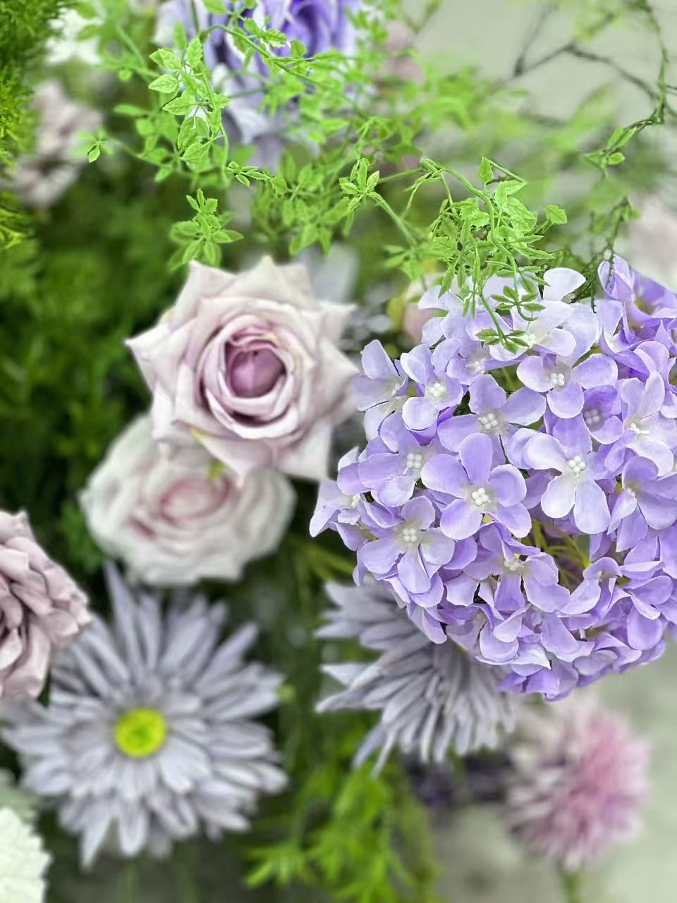 Close view of lavender hydrangeas and mauve roses