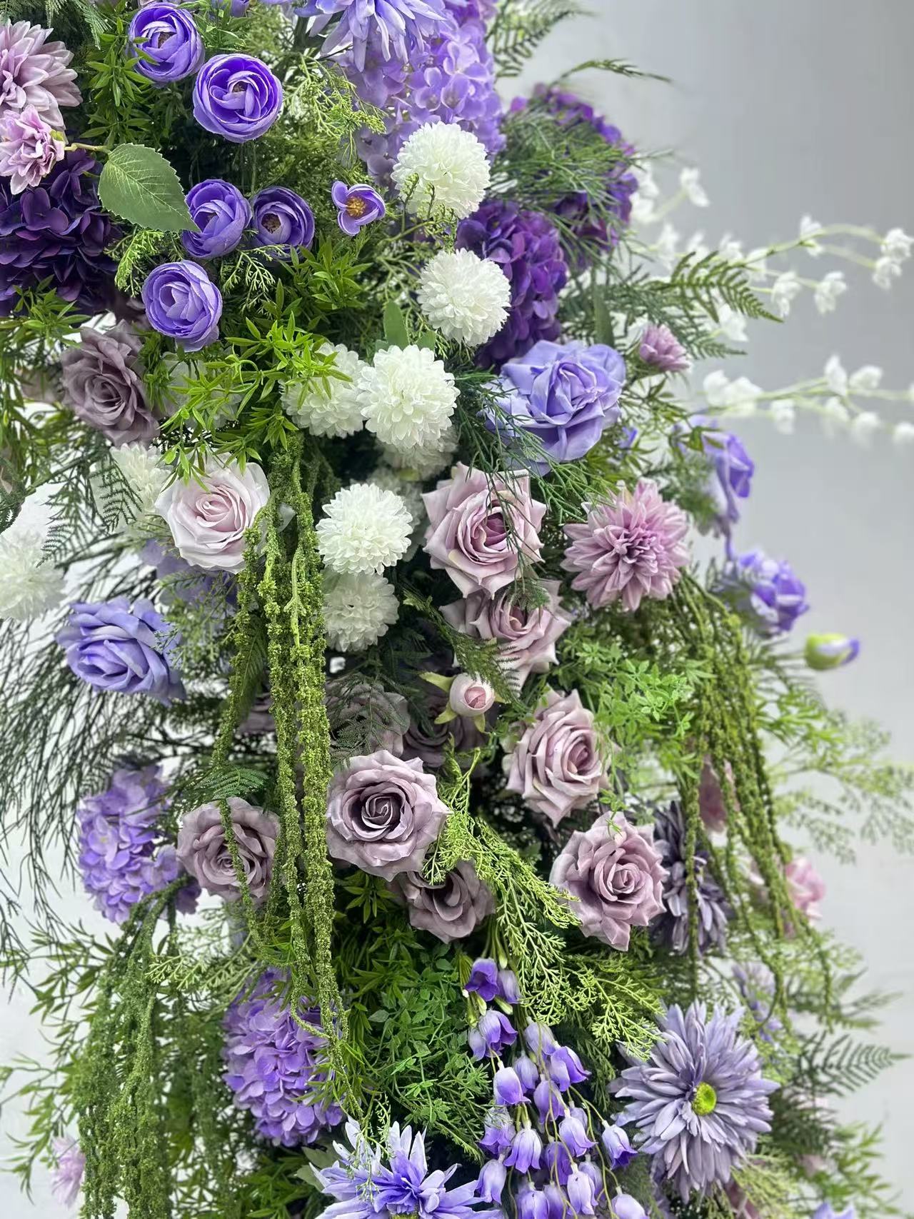 Close view of lavender roses and cascading greenery